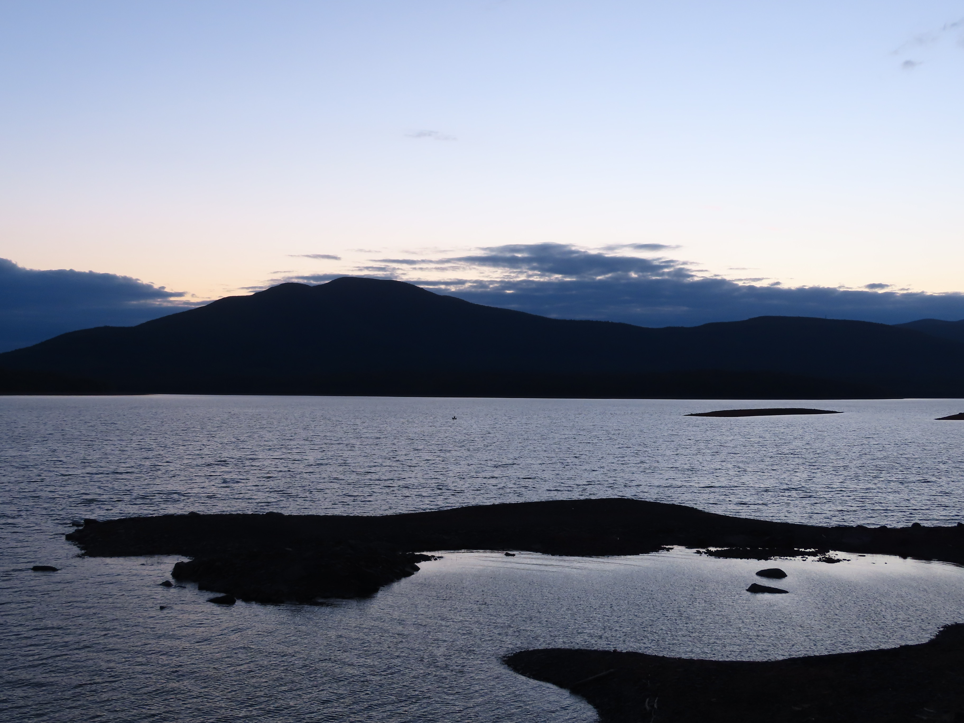 Sunset at lake with mountains in the background